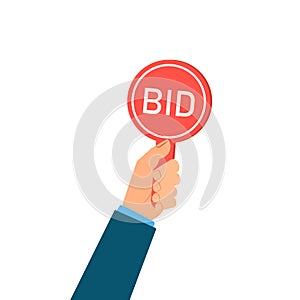 Hand holding auction paddle bid.