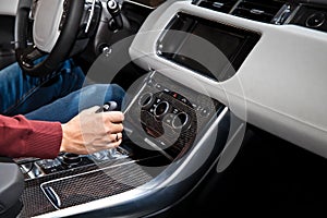 Hand holding automatic transmission in car
