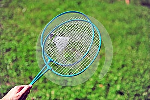 Hand holding badminton rackets