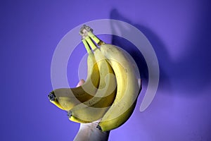 Hand holding bananas