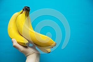 Hand holding bananas