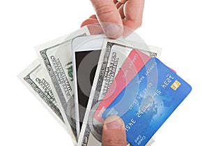 Hand holding banknotes credit cards and a tablet