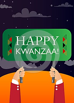 Hand holding banner with Happy Kwanzaa! text.