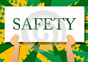 Hand holding banner with Safety text