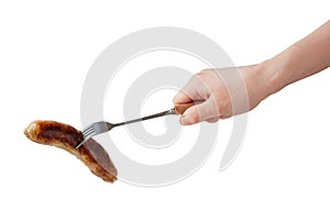 Hand holding barbecue fork BBQ sausage