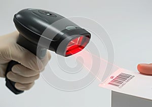 Hand holding barcode scanner reading qr code isolated on white background
