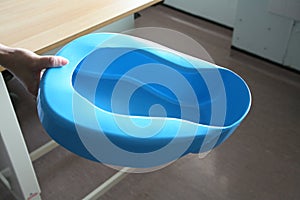 Hand holding bedpan