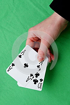 Hand holding best classic blackjack combination ten and ace of c