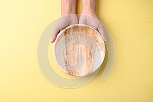 Hand holding betal palm leaf plate Biodegradable, Compostable, Disposable or Eco friendly plate