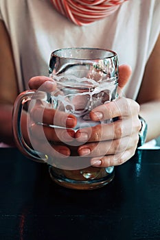 Hand holding big glass of beer