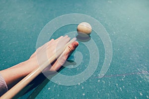 Hand holding billiard stick cue ready to shot ball