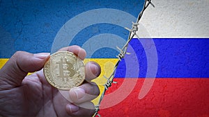 Hand holding a bitcoin gold coin symbol of cryptocurrency on the flag of Russia and Ukraine steps with barbed wire concept illustr