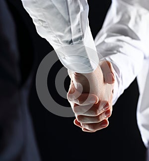 Hand holding on black background