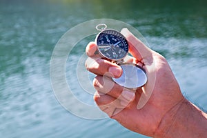 Hand holding the black compass