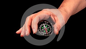Hand holding the black compass