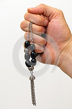 Hand holding a black komboloi