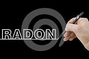 Hand holding a black pencil drawing a perfectly straight white line on black background with Radon text