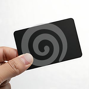 Hand holding a black rectangular object against a white background