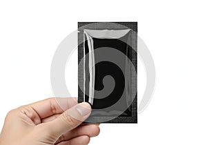 Hand holding a black rectangular object with reflective surface