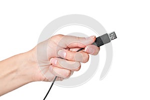 Hand holding black USB cable