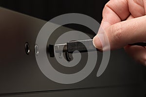 Hand holding black USB cable