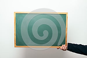 Hand holding a blank blackboard with copyspace