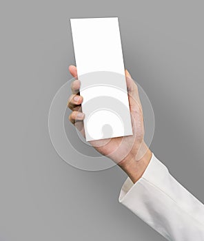 Hand holding a blank brochure booklet mock up photo
