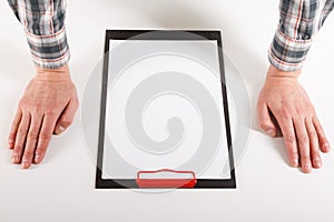 Hand holding blank clip board with white paper design mockup