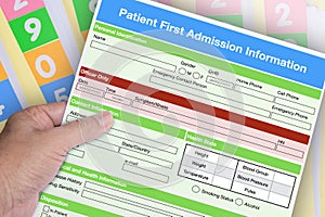 Hand holding blank patient first admission form