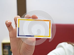 Hand holding blank visit card