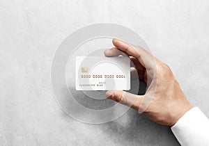 Hand holding blank white credit card mockup with chip
