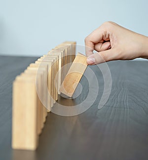 Hand holding blocks wood game, Concept Risk of management and strategy plan, growth business success process and team work