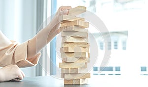 Hand holding blocks wood game, Concept Risk of management and strategy plan, growth business success process and team work