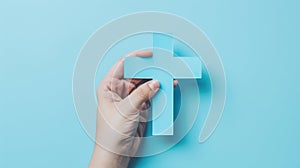 The hand holding blue cross.AI generated image