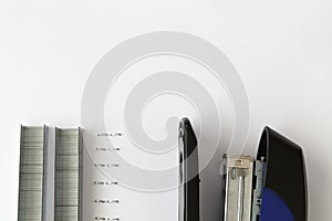 Hand holding blue stapler stapling papers