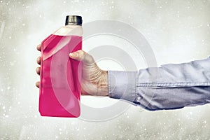 Hand Holding a Bottle of Antifreeze photo