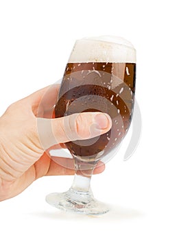 Hand holding bottle of beer and beer mug