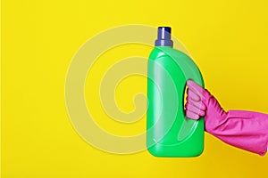 Hand holding bottle with detergent