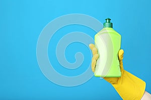 Hand holding bottle with detergent