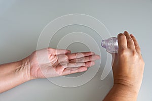 Hand holding a bottle of gel alcohol for desinfection and prevention of corona virus covid 19 infection disease, healthcare 2