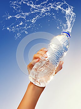 Hand holding a bottle of water