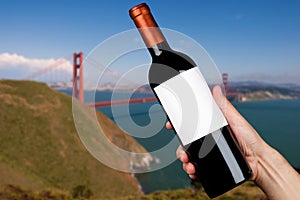 Hand holding a bottle of wine