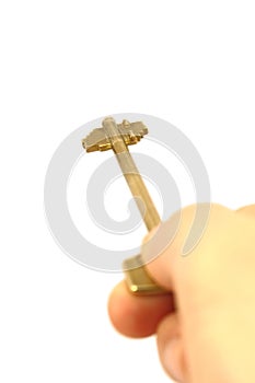 Hand holding brass key