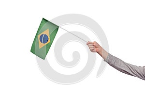 Hand holding Brazil flag isolated on white background. Ordem e Progresso photo