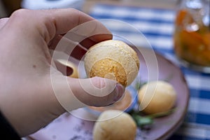 Hand holding Brazilian pao de queijo