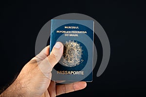 Hand holding Brazilian passport