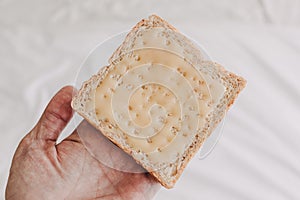 Hand holding bread with sweetened condensed milk. Easy dessert.