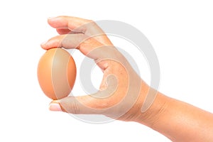 Hand holding a brown egg
