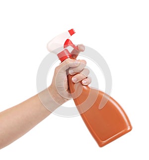Hand holding brown plastic spray bottle.