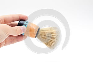 Hand holding brush for shaving beard